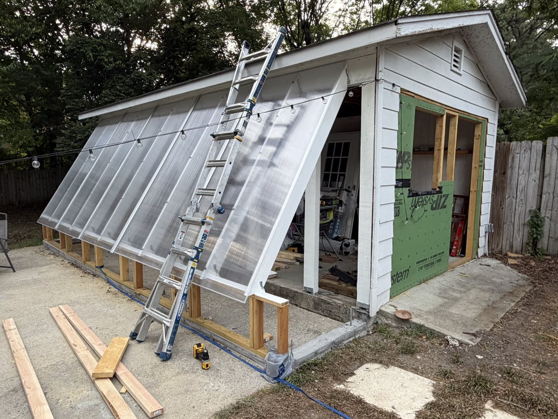 DIY passive solar greenhouse built onto a garage